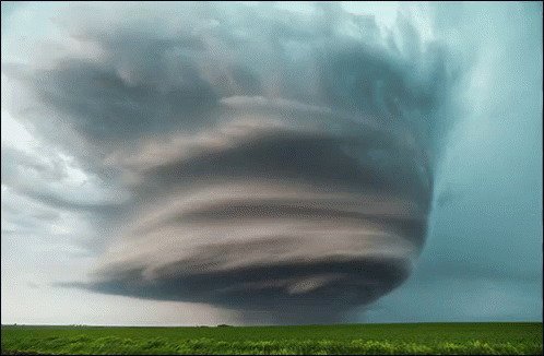 Large Tornado Moving Through Grass Field