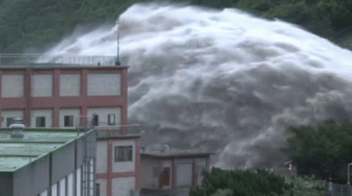 Large Waterfall Flowing Down Building GIF