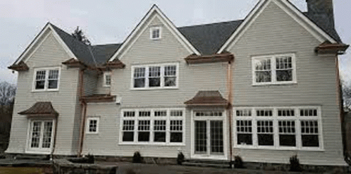 Large White House With Many Windows And Chimney GIF