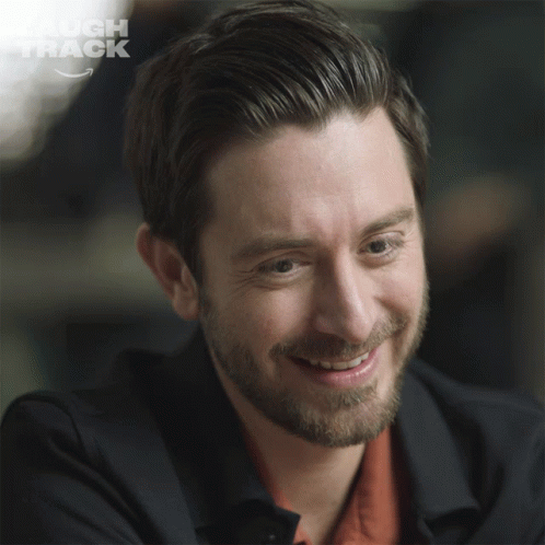 Laugh Track Logo Behind Man's Face