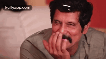 Laughing Man With Mustache Covering Mouth GIF
