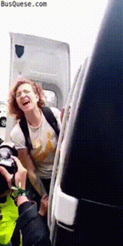 Laughing Woman Getting Out of Van With Hood Open