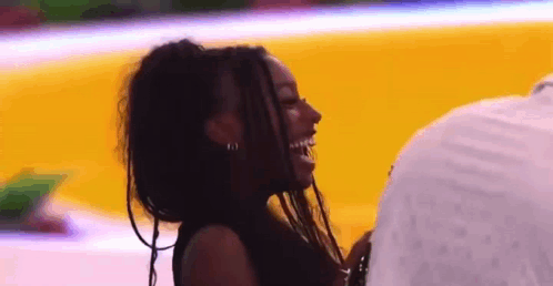Laughing Woman with Dreadlocks and Man on Basketball Court
