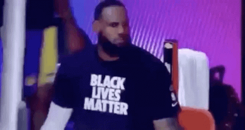 lebron james is wearing a black lives matter t-shirt while walking on stage .