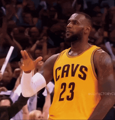 Lebron James Is Wearing A Yellow Jersey With Cavs 23 On It GIF