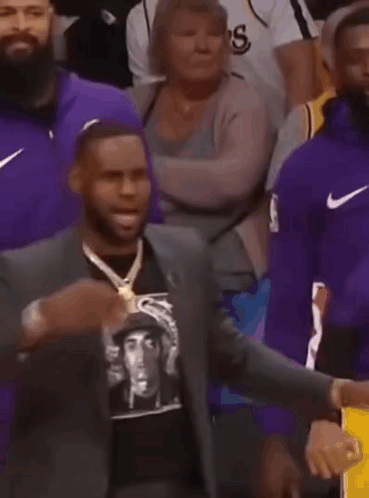 LeBron James Watching Basketball in Suit and Gold Chain