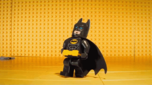 Lego Batman Standing in Front of Yellow Bricks
