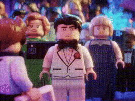 Lego Man in Tuxedo and Bow Tie Standing Before Group