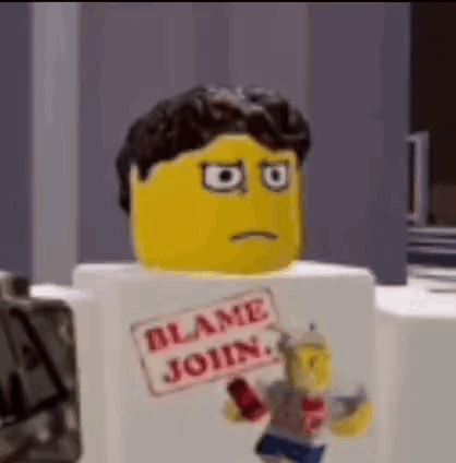 Lego Man With Blame Join Sign on White Box