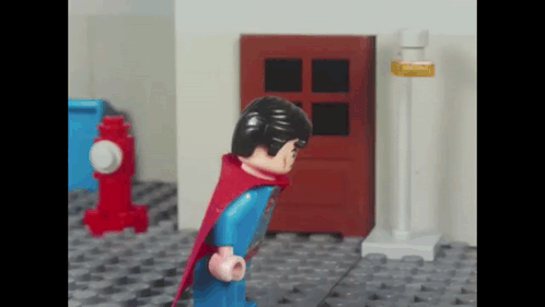 Lego Superman Standing in Front of Red Door