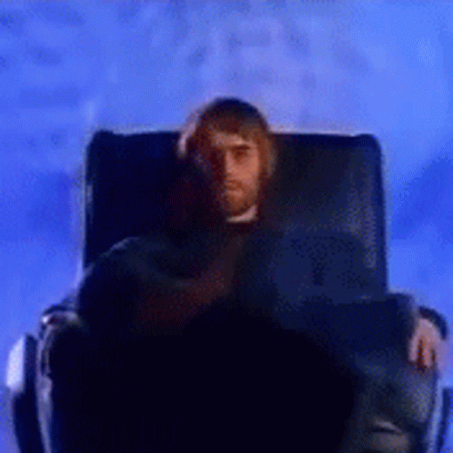 Liam Gallagher Sitting On Black Chair GIF
