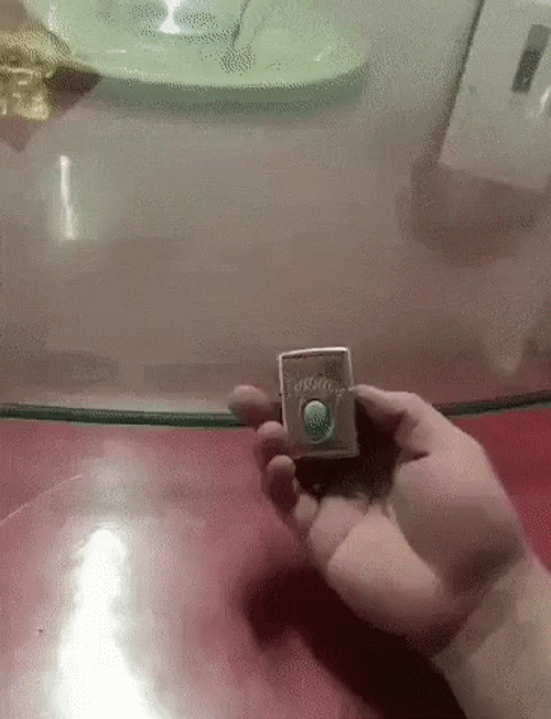 Lighting Hands Using Lighter To Light Table GIF