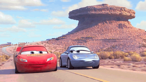 Lightning Mcqueen And Sally Are Driving Down A Desert Road GIF