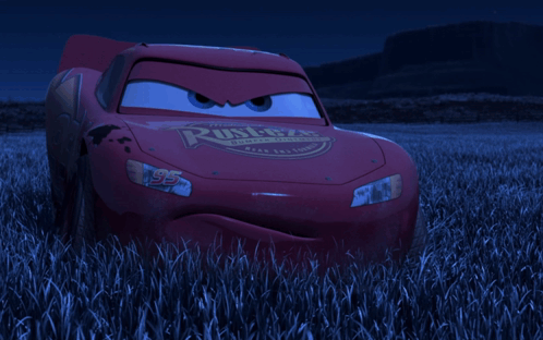 Lightning Mcqueen From The Movie Cars Is Standing In A Field Of Tall Grass GIF