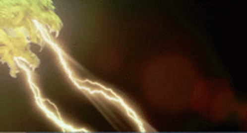 Lightning Strikes Against Dark Background With Yellow Light