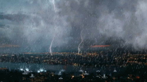 Lightning Strikes During A Heavy Rain Storm Over A City GIF