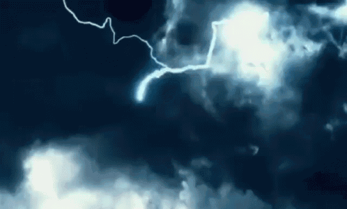 Lightning Strikes In A Dark Cloudy Night Sky GIF