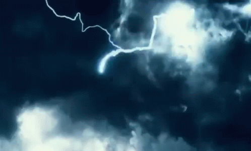 Lightning Strikes In A Dark Cloudy Sky At Night GIF