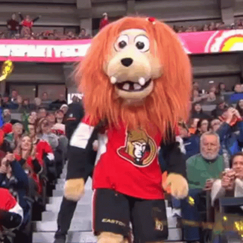 Lion Mascot Dancing in Front of Crowd