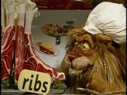 Lion With Glasses Looking at Ribs