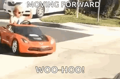 Little Boy Driving Red Toy Car