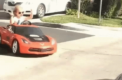 Little Boy Driving Red Toy Car