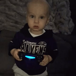 Little Boy in Baltimore Ravens Shirt Holding Video Game Controller