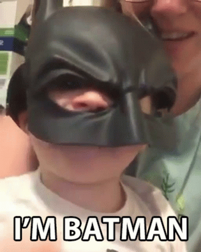 Little Boy In Batman Mask Held By Man GIF