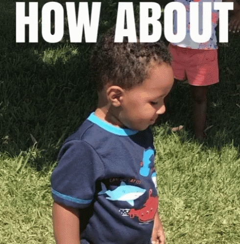 Little Boy in Blue Shirt With 3 in Grass