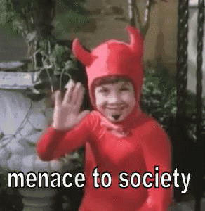 Little Boy in Devil Costume Waving Says Menace to Society