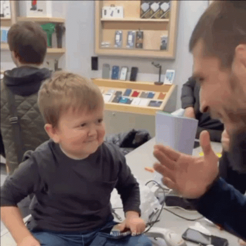 Little Boy In Front Of Phone Display GIF