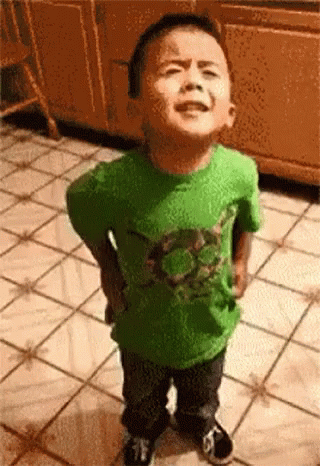 Little Boy in Green Shirt Hands on Hips