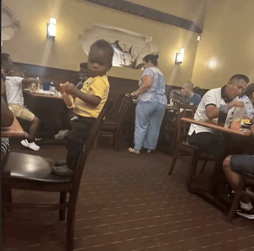 Little Boy in Yellow Shirt in Restaurant