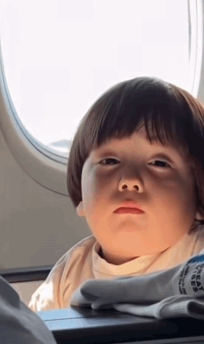 Little Boy Looking Out Airplane Window
