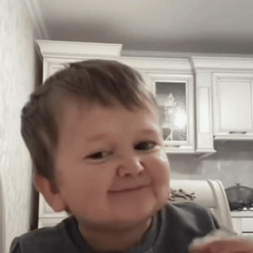 Little Boy Making Funny Face Holding Food GIF