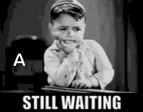 Little Boy Sitting at Desk Waiting