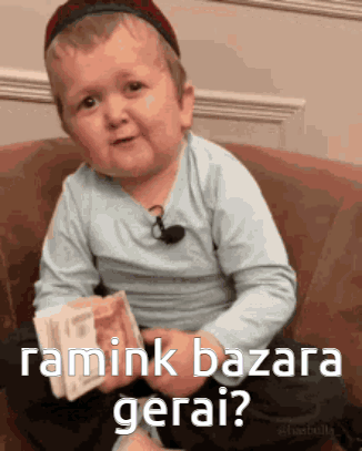 Little Boy Sitting On Couch Holding Money Asking Ramink Bazara Gerai GIF