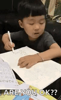 Little Boy Writing in Notebook