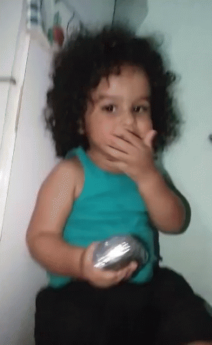 Little Curly Hair Girl Covering Mouth with Silver Object