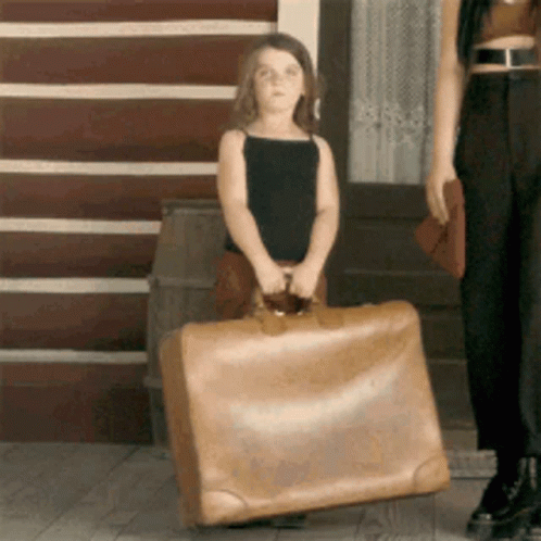 Little Girl Carrying Large Suitcase