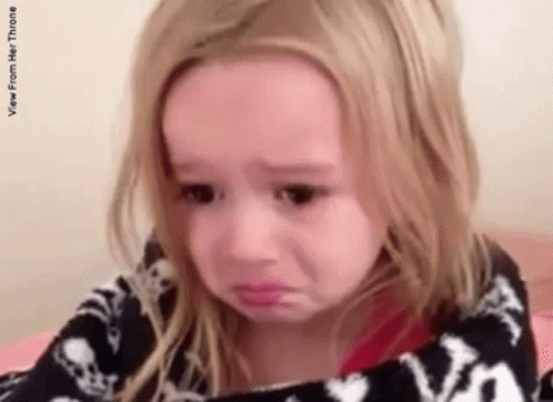 Little Girl Crying Wrapped in Blanket