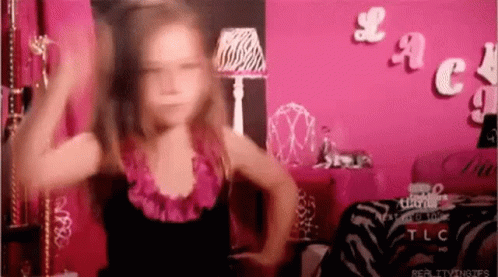 Little Girl Dancing in Front of Pink Lace Wall