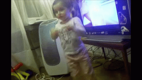 Little Girl Dancing in Front of Windows Laptop