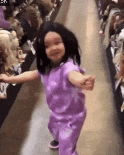 Little Girl Dancing in Purple Outfit