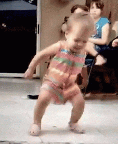 Little Girl Dancing While People Watch