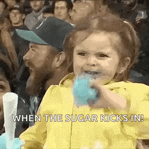 Little Girl Eating Blue Cotton Candy in Crowd