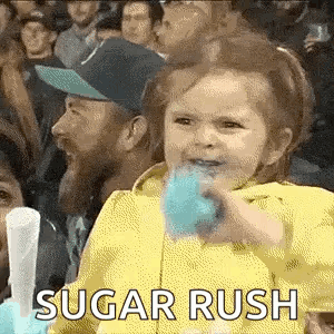 Little Girl Eating Cotton Candy In Crowd
