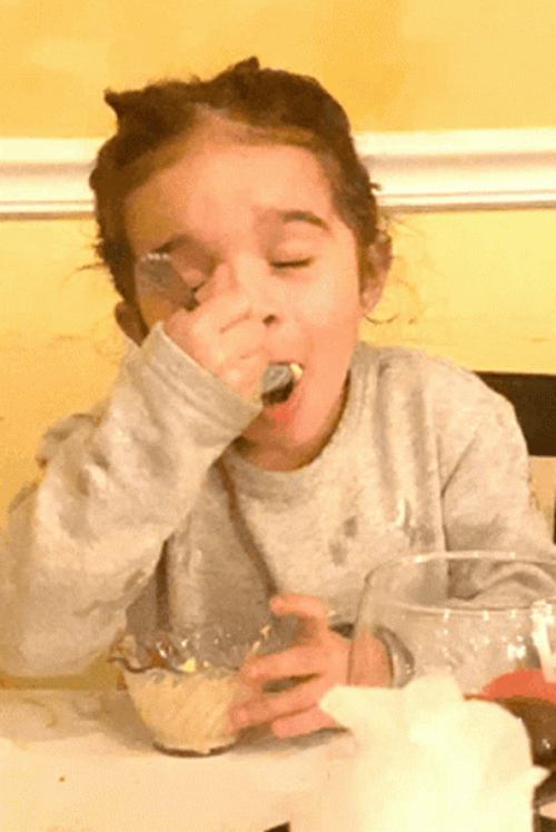 Little Girl Enjoying Delicious Food GIF