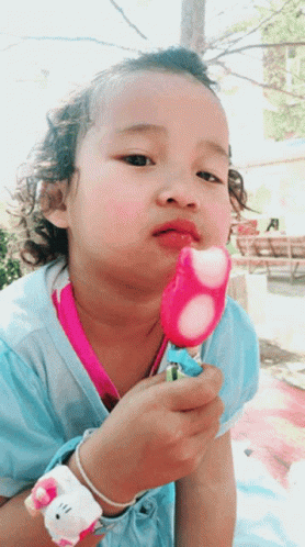 Little Girl Enjoying Fruity Popsicle GIF