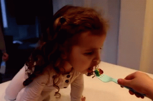 Little Girl Fed by Fork